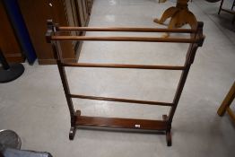 An Edwardian mahogany towel rail, of traditional design with octagonal section rails and square