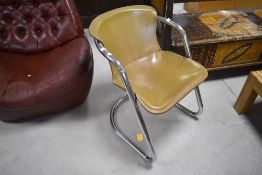 A 1960's chrome and stitched tan leather cantilever chair, in the manner of Metaform, seat height