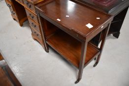 A vintage stained wood two-tier tea trolley/card table, of typical design with shallow galleried to