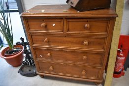 A 19th century grained pine chest of drawers, the rectangular top with rounded front corners and