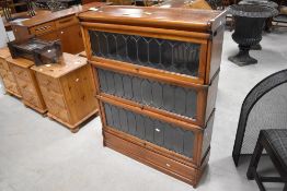 A Globe-Wernicke & Co Limited mahogany three-tier sectional stacking bookcase with leaded glass