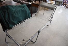 A group of three Lafuma folding sun loungers, each with canvas carrycase