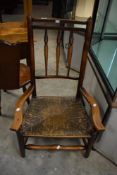An attractive 19th century rus-seated spindle-back armchair, having a double top rail over turned