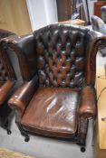 A late 1980's reproduction Chesterfield style deep-buttoned wing-back armchair, of traditional
