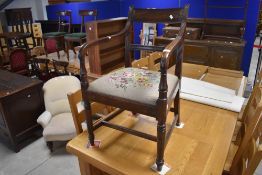 A 19th Century mahogany carver chair having drop in woolwork seat , stamped to front for Gillows