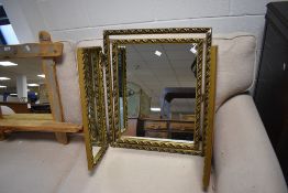 A vintage gilt-framed triple mirror, with moulded foliate decoration 63cm high
