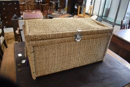A woven sea grass type storage box, of rectangular form with carrying handles to sides 44cm x 85cm x