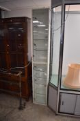 A tall modern glass fronted lockable and illuminated display unit, with two long glass doors