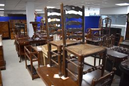 A set of four rush seated elm ladder-back dining dining chairs, of 19th century design, seat