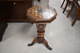 A Victorian mahogany pedestal work/games table, having a hinged octagonal form with inlaid chequer