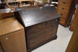 An 18th century oak bureau, of traditional design with fall-front enclosing an attractive interior