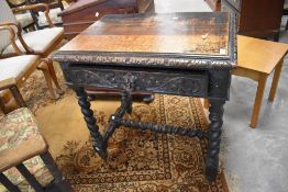 A Victorian carved oak single drawer side table, the moulded rectangular top with foliate detail
