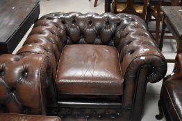 A late 1980's Thomas Lloyd two-piece chestnut brown leather Chesterfield type suite, of typical