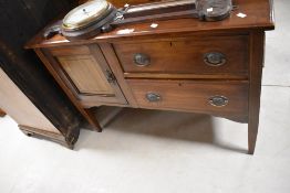 An Edwardian mahogany side cabinet, having a raised and moulded back over the rectangular top, two