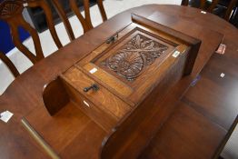 Local interest* Ernest John Oldcorn, an Arts & Crafts oak wall mounted cupboard, having a slender