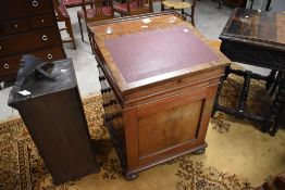 A 19th century mahogany Davenport, of typical slope-fronted form with a figured mahogany panelled