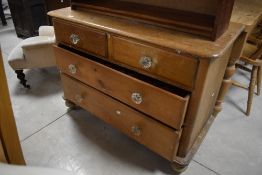 A Victorian pine chest of drawers, the moulded rectangular top with rounded front corners over two