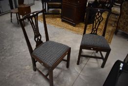 A pair of George III design mahogany splaat-back dining chairs, having a shaped top-rail over the