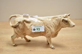 A 20th-century Beswick pottery Charolais Cow figurine, model 3075A, with a light brown glossy
