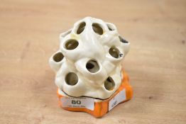 A small Art Deco Clarice Cliff 'Bizarre' ware pottery flower frog, featuring a rocky coral-like