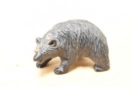 A small 20th-century Folk Art Black Forest-style carved wood bear, featuring detailed fur