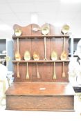 Presumed 19th-century oak spoon rack and candle box, featuring a decorative back plate, a hinged top