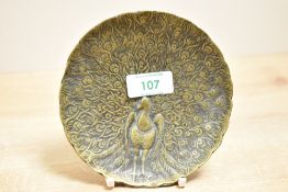 A 20th-century brass peacock jewellery dish, featuring an array of embossed outstretched tail