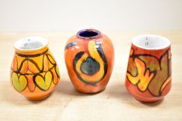Three small mid 20th-century Poole Pottery bud vases, to include two ?Delphis? examples and one ?