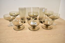 A selection of 20th-century 'smokey' studio art glass, featuring five twisted base coupes; three