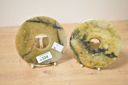 A pair of Chinese carved variegated stone Bi/Yubi type discs, of circular form with central