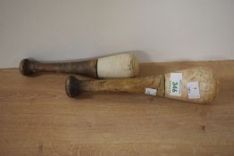 Two late 19th-century stoneware apothecary pestles, having turned wooden handles, of graduated