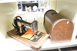 Thought to be early 20th-century The Avenue sewing machine, featuring a hand crank mechanism and