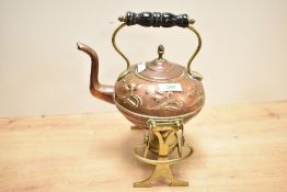 An early 20th-century Beldray Art Nouveau-style copper and brass tilting spirit kettle and stand,