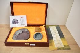 A modern Chinese Qingqu inkstone, carved from Songhua stone and sold along with a water bowl and
