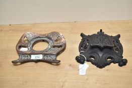 Two early 20th-century Art Nouveau metal inkwells, to feature an ornately decorated iron example