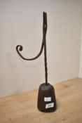 Thought to be late 18th to early 19th-century wrought iron rushlight holder, upon a hard wood