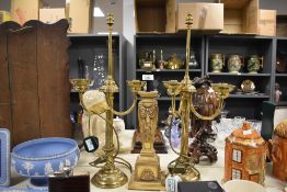 Two 20th-century brass candelabra-style table lamps; sold with a resin draping swag and ribbon-motif