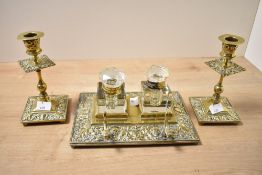 A Victorian brass double inkwell with matching candlesticks, featuring floral and foliate
