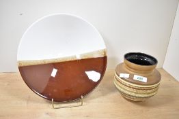 A small mid-20th-century West German ceramic vase, featuring a moulded multicoloured ribbed pattern,