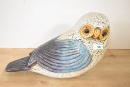 A large contemporary hand carved wooden seated owl figurine, featuring colourful hand painted