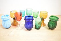 A quantity of 19th to 20th-century colourful glassware, to feature a pair of amber Roemer-style wine