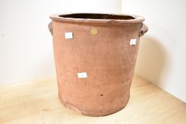 A large early 20th-century studio pottery pot, of cylindrical form with small lug handles, unmarked,