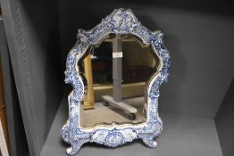 A 19th-century Dutch Delft framed mercury silver cut mirror, of ornate scrolled form, featuring