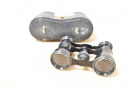 A pair of small 19th-century black metal opera glasses, having original black leather case, markings
