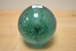 A large 19th-century green glass dump paperweight, featuring a rich green colour with trapped air