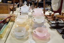 A quantity of vintage Arcopal France translucent glass cups and saucers, of soft pastel pinks,
