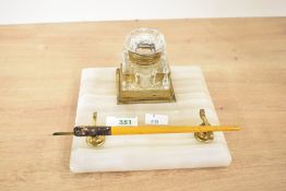 A Victorian hardstone inkwell desk stand, with brass mounts, a cut-crystal glass inkwell with hinged