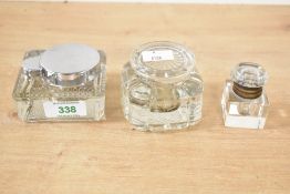 Three late 19th to early 20th-century glass inkwells, to feature a small cut glass crystal example