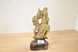 A 20th-century Chinese hardstone carved decorative figure of an immortal, presumed to feature