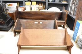 Three late 19th to early 20th-century wooden book troughs, of varying sizes and styles, unmarked, (